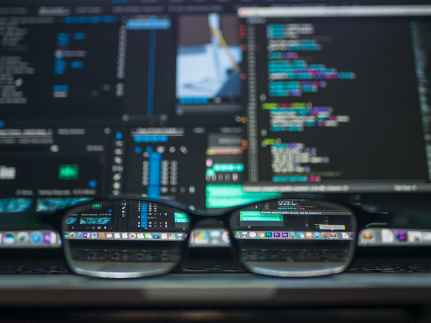 coding screen with glasses resting in front